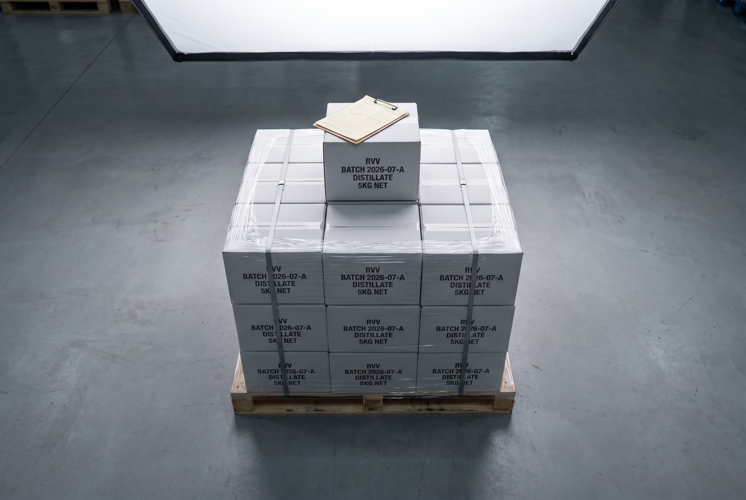Palletized shipment of shrink-wrapped RVV-stamped cartons on clean warehouse concrete with shipping manifest